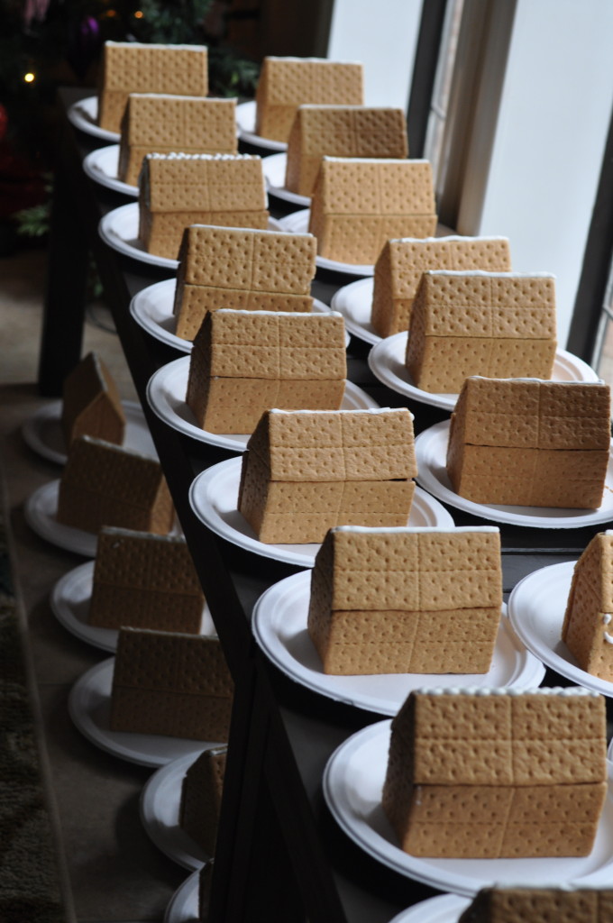 Gingerbread houses pre-assembled with hot glue for a decorating party - Eat This Up.