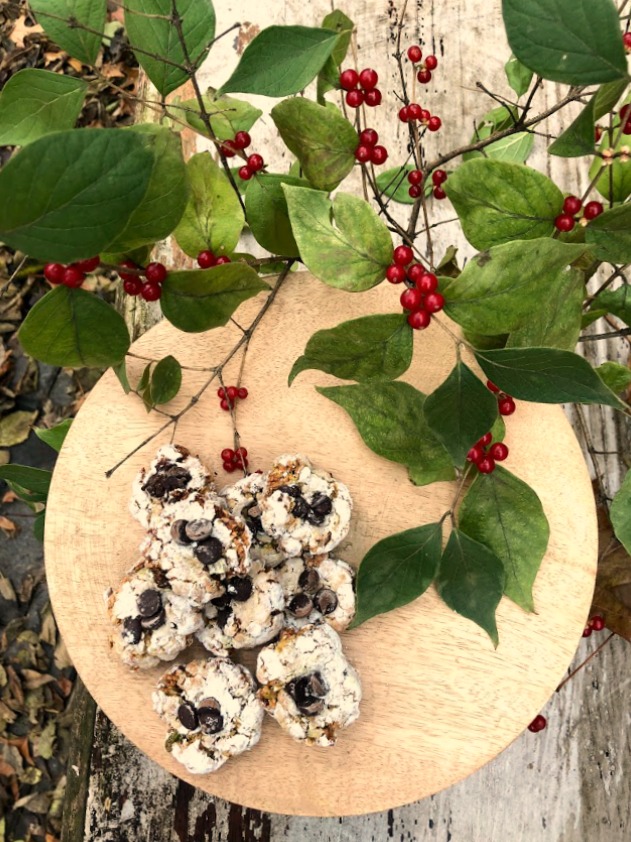 Pistachio Almond Crinkle Cookies on a Wood Pedestal - Hello Lovely Studio. #hellolovelystudio #cookierecipe #pistachio