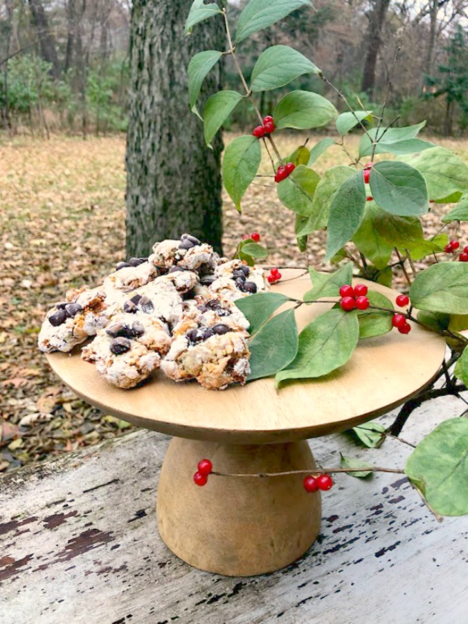 Pistachio Almond Crinkle Cookies on a Wood Pedestal - Hello Lovely Studio. #hellolovelystudio #cookierecipe #pistachio