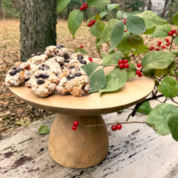 Pistachio Almond Crinkle Cookies on a Wood Pedestal - Hello Lovely Studio. #hellolovelystudio #cookierecipe #pistachio