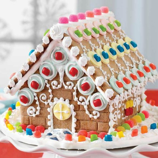 Colorful and fanciful gingerbread house decorated with circles - King Arthur Flour. #gingerbreadhouse #holidaybaking #christmasdiy