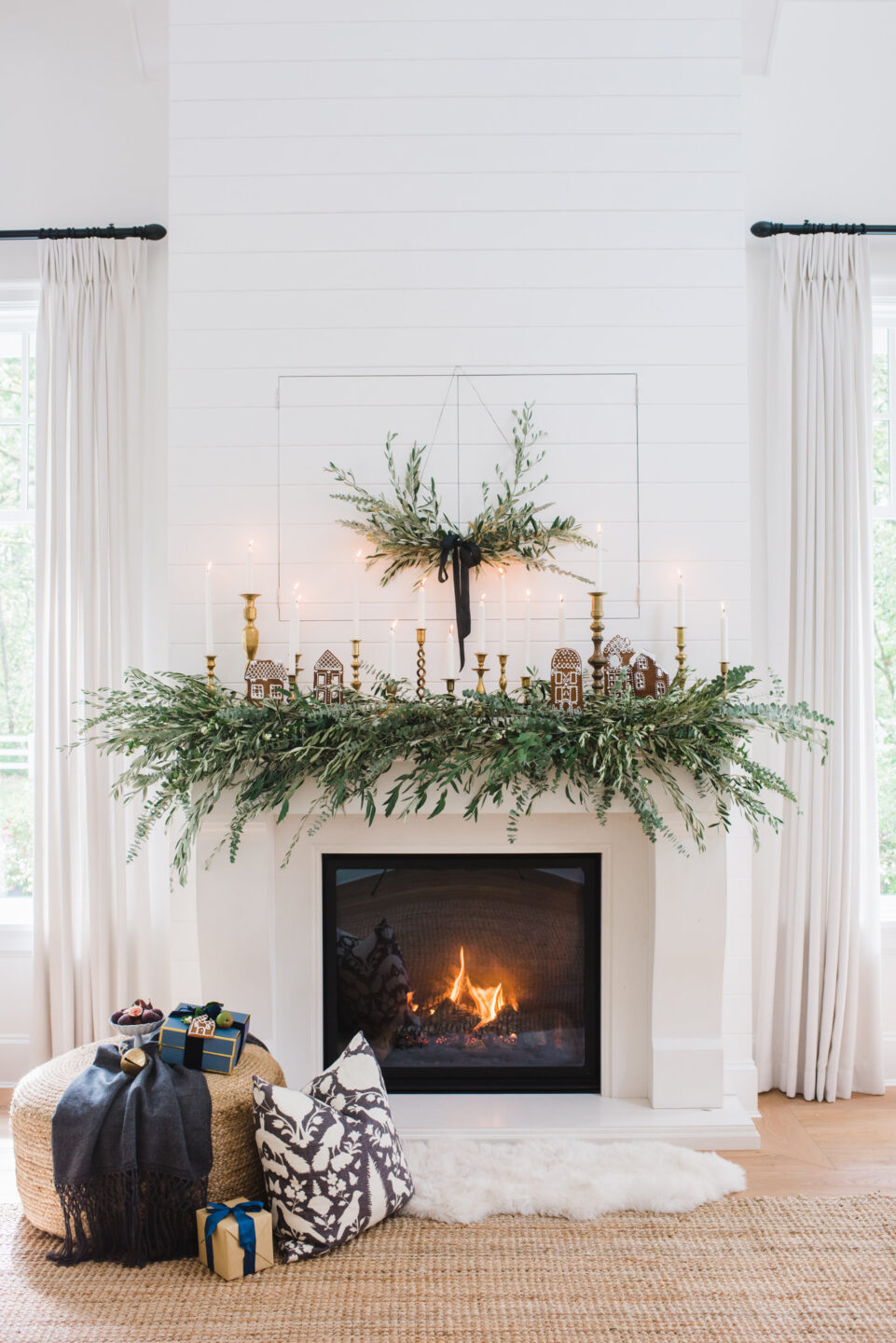 Beautiful holiday greenery on a white fireplace - Monika Hibbs. #holidaydecor #fireplace #garland