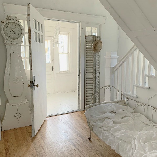 Charming Scandinavian farmhouse with white Swedish mora clock and French daybed - My Petite Maison.