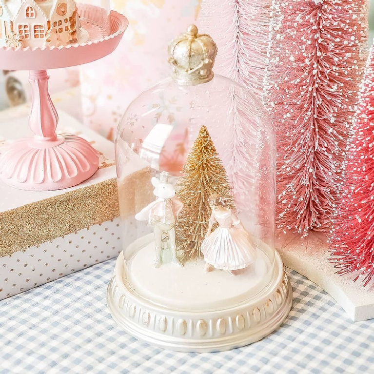 Magical pink Christmas vignette with snow globe and bottle brush trees @simpledaysmatter.