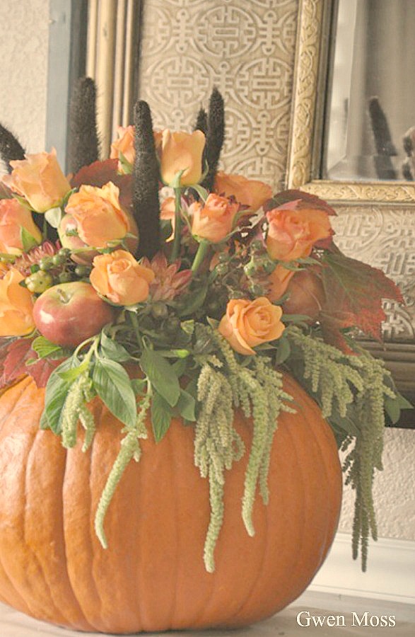 Elegant pumpkin hued roses in a pumpkin as vase centerpiece for fall beauty from Gwen Moss. #centerpiece #pumpkin #floralcenterpiece #tablescape #thanksgivingdecor