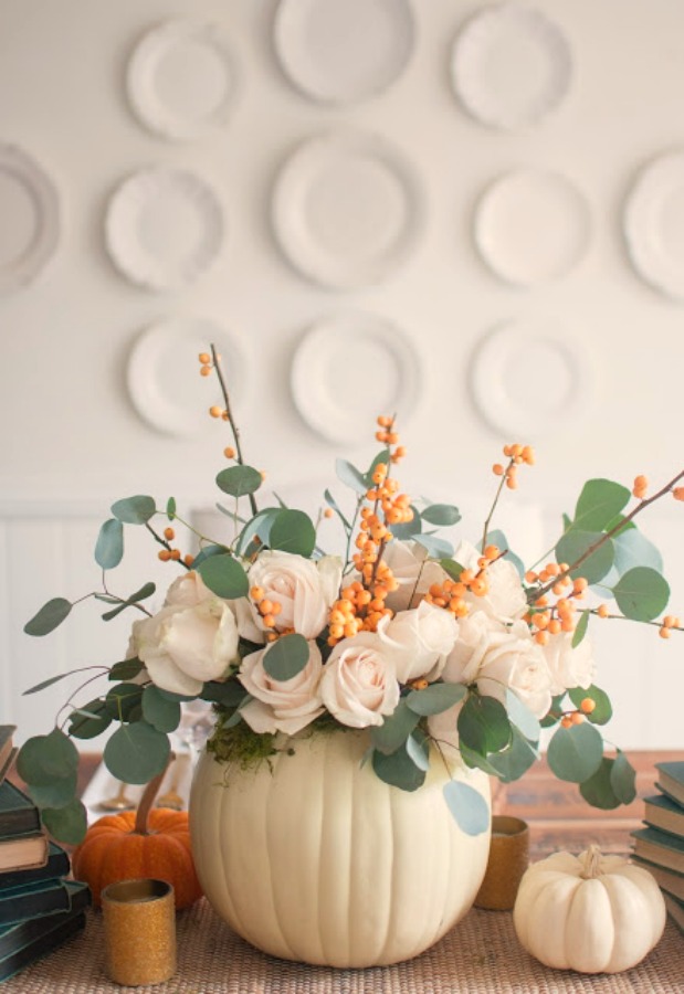 Gorgeous and simple fall centerpiece with white pumpkins, roses, bittersweet and eucalyptus - Gwen Moss. #falltable #pumpkincenterpiece #thanksgiving #tabledecor
