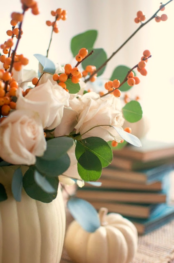 Gorgeous and simple fall centerpiece with white pumpkins, roses, bittersweet and eucalyptus - Gwen Moss. #falltable #pumpkincenterpiece #thanksgiving #tabledecor