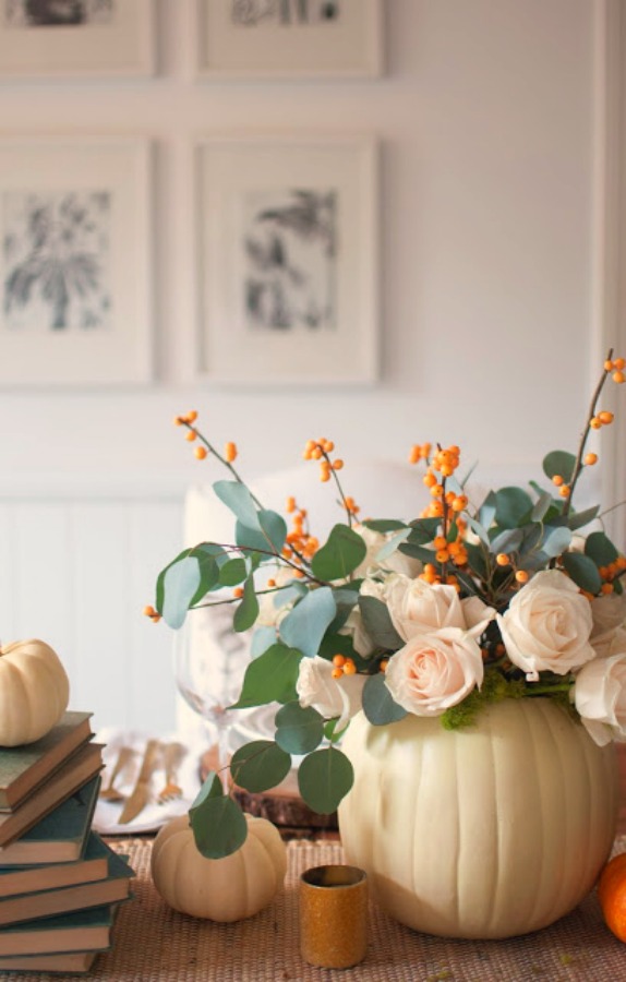 Gorgeous and simple fall centerpiece with white pumpkins, roses, bittersweet and eucalyptus - Gwen Moss. #falltable #pumpkincenterpiece #thanksgiving #tabledecor
