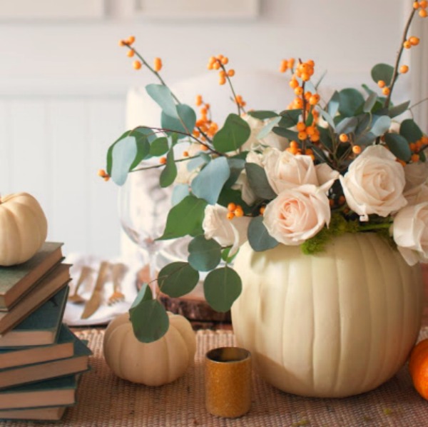 Gorgeous and simple fall centerpiece with white pumpkins, roses, bittersweet and eucalyptus - Gwen Moss. #falltable #pumpkincenterpiece #thanksgiving #tabledecor