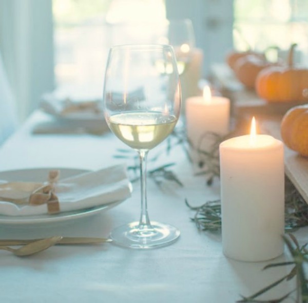 Simple lovely fall table Thanksiving tablescape idea with long wood board and mini pumpkins - Gwen Moss. #falltable #tabledecor #thanksgiving #tablescape