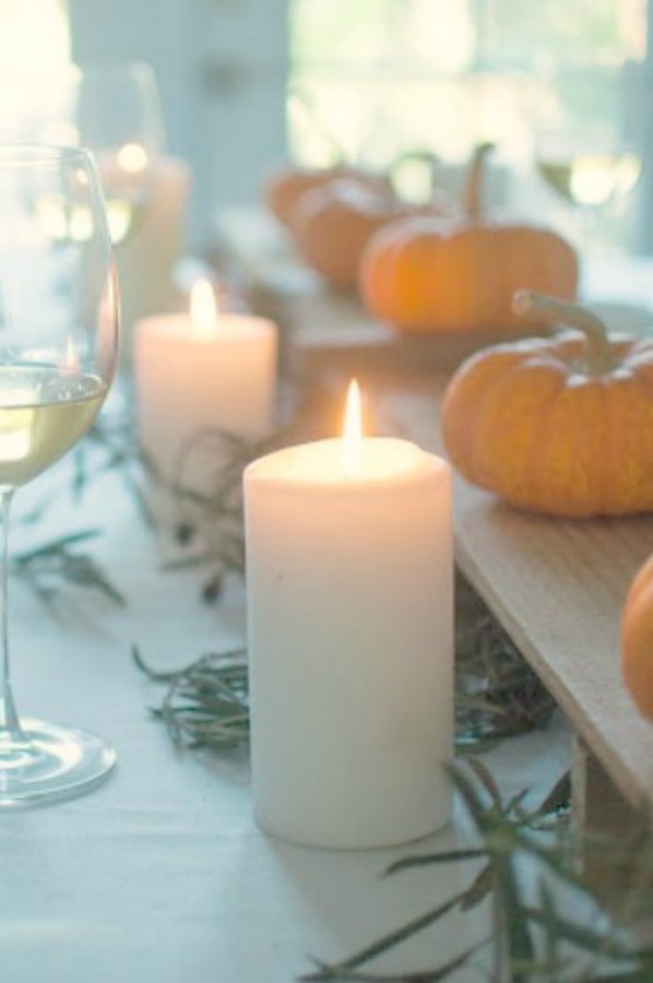 Simple lovely fall table Thanksiving tablescape idea with long wood board and mini pumpkins - Gwen Moss. #falltable #tabledecor #thanksgiving #tablescape