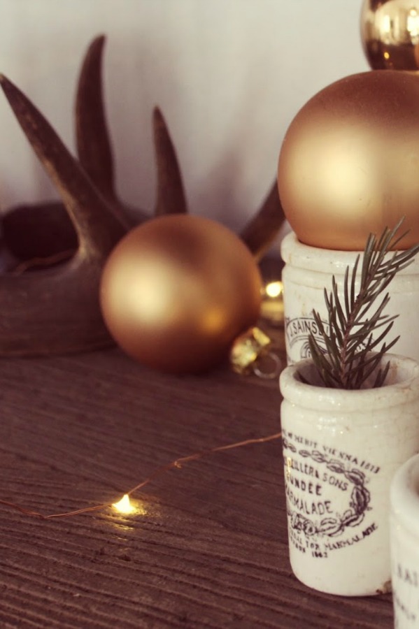 Vintage marmalade jars with greenery and gold bulbs in my Christmas home - Hello Lovely Studio. #christmasdecor #hellolovelystudio #vintagechristmas