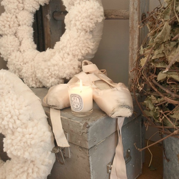 White Christmas pom pom wreath and pink ballet slippers round out a holiday vignette from Hello Lovely Studio.