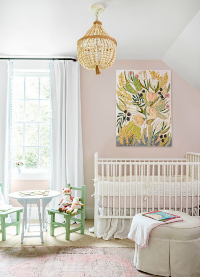 Pale pink nursery with white crib - walls painted Sherwin Williams Intimate White. #pinkpaintcolor #intimatewhite #interiordesign #pinknursery