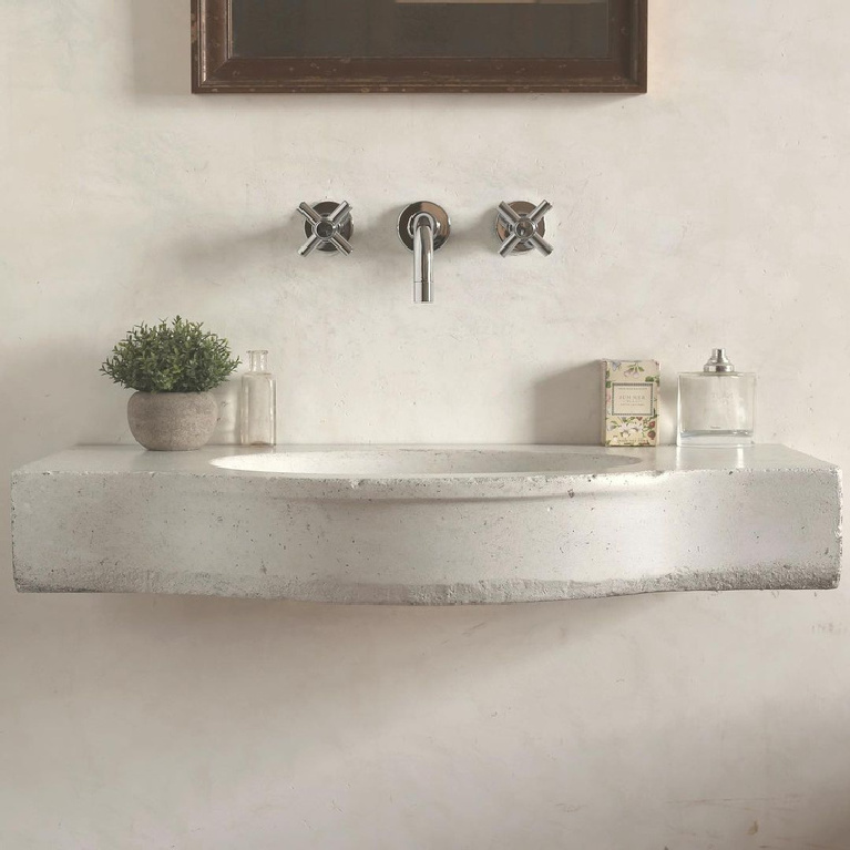 Serene and beautiful white limestone sink with modern wall mount taps in an ethereal bath - @atmosphyrellc