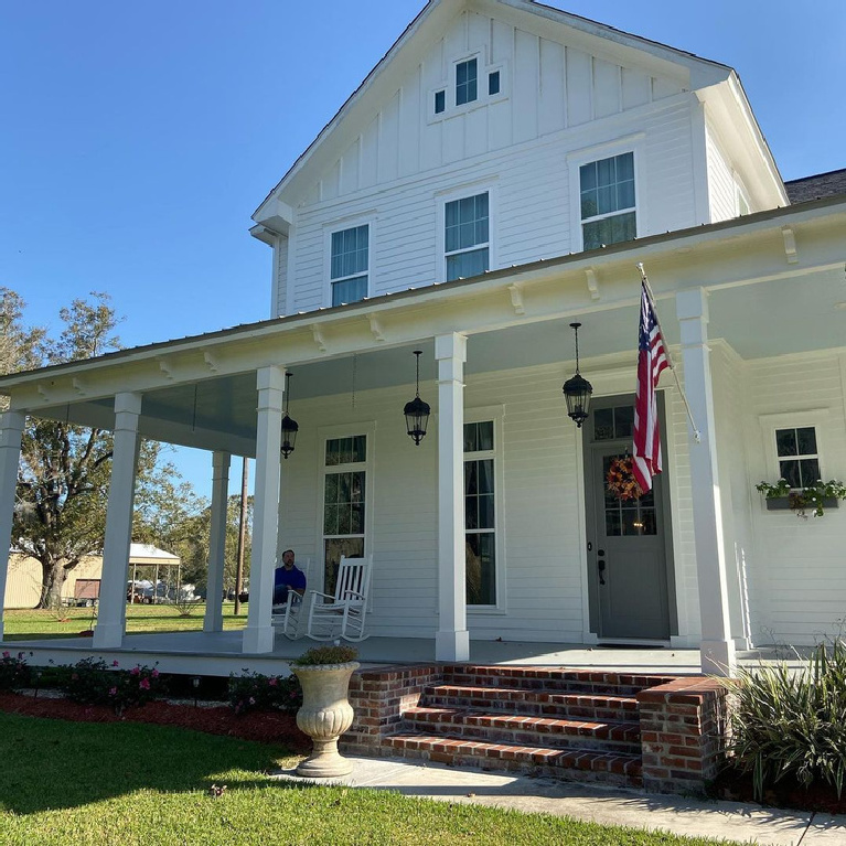 Beautiful new white farmhouse exterior painted White Dove (Benjamin Moore) - @houseonbluff. #whitedovepaint #whitehouseexterior #whitepaintcolors #houseexteriors #whitefarmhouse