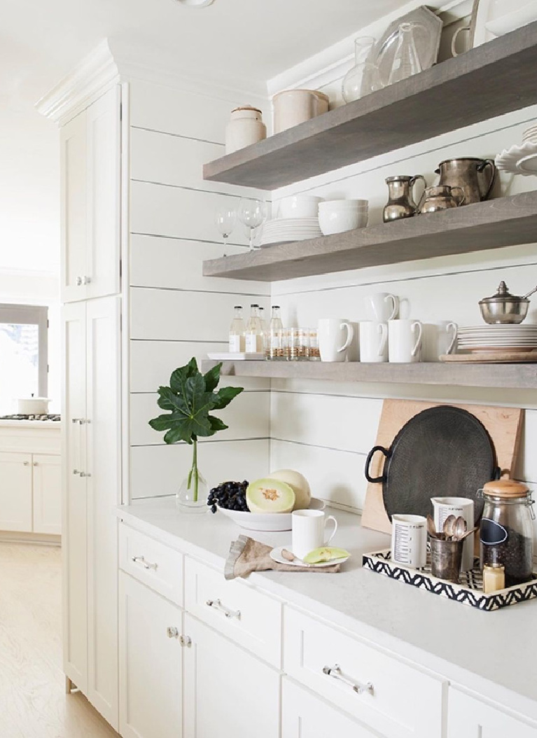 Gorgeous floating shelves and white shiplap painted White Dove in a designer's Atlanta kitchen - Sherry Hart. #floatingshelves #whitekitchen #whitedovepaint #benjaminmoorewhitedove #shiplap