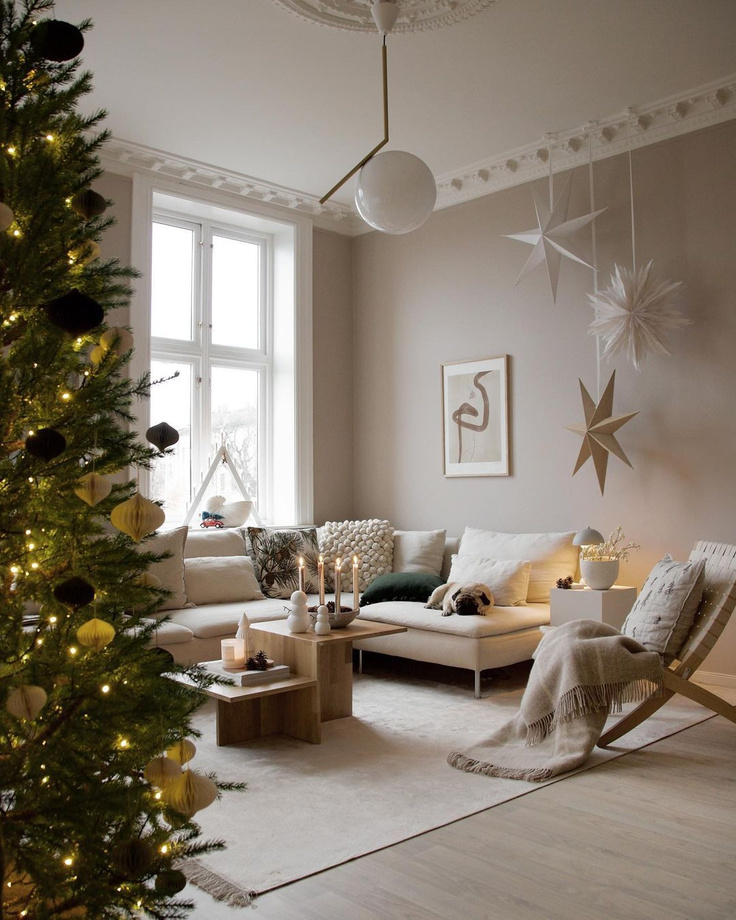 Beautiful Scandinavian Christmas decorated living room with dog lounging on Bemz covered sofa - Niblu Home. #bemz #nibluhome