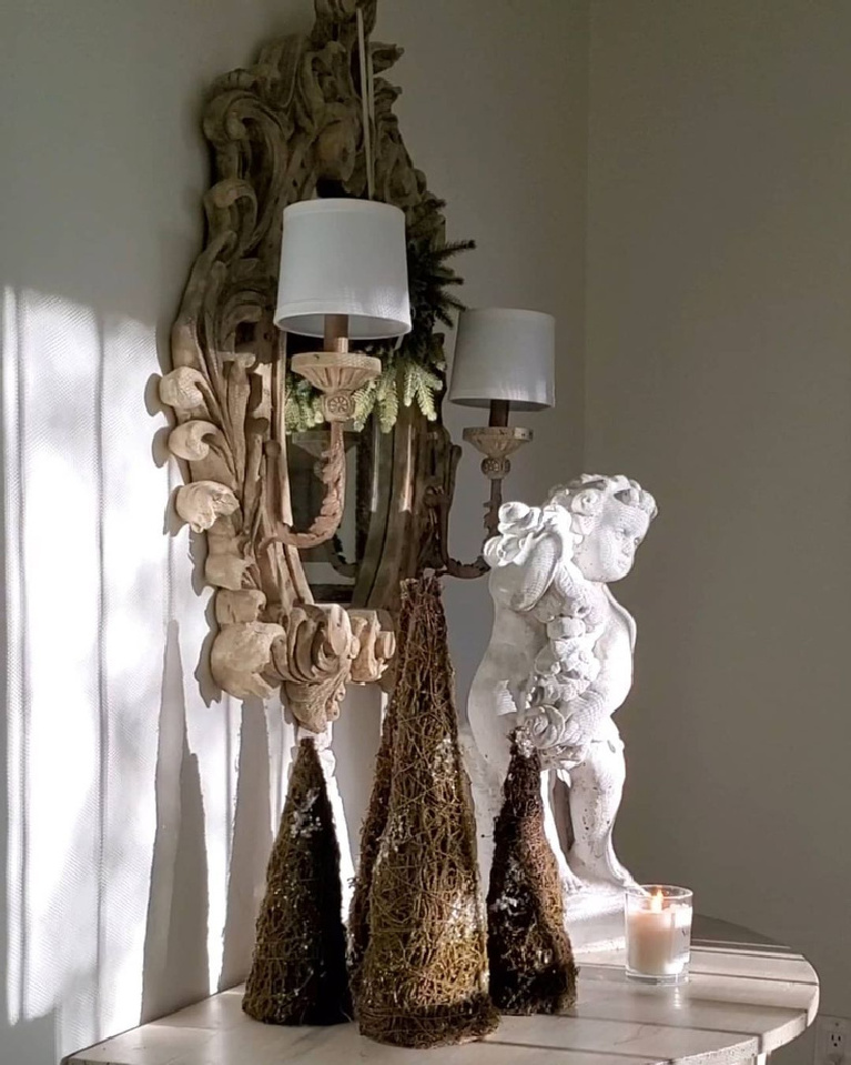 French country Christmas decor vignette with moss trees, antique sconce and cherub - TheFrenchNestCoInteriorDesign.