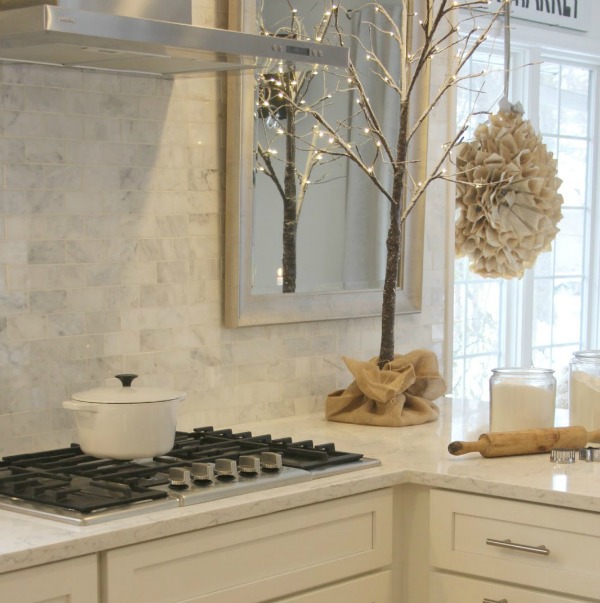 White Christmas decor in my classic white kitchen - Hello Lovely Studio. #hellolovelystudio #christmasdecor #whitechristmasdecor