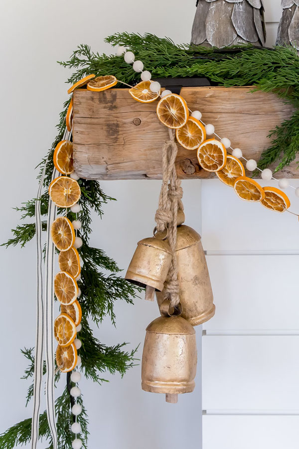Citrus garland on a fireplace for a rustic farmhouse Christmas look from House of Jade Interiors. #citrusgarland #christmasdecor #swedishchristmas #handmadechristmas
