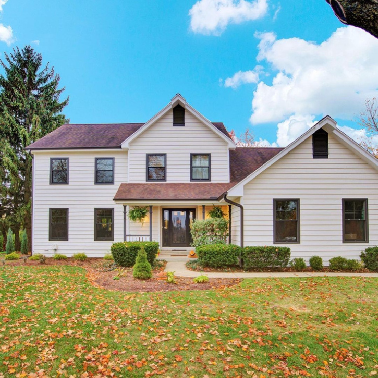 White house exterior in Northern Illinois painted Sherwin Williams Shoji White - Christie Kenny Interiors. #shojiwhite #shojiwhitepaint