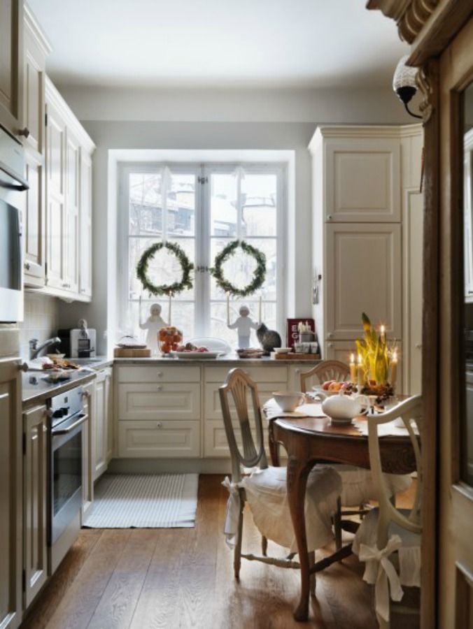Swedish Christmas decor inspiration from a kitchen in Sweden with wreaths in teh windows - Jill Sorensen. #swedishchristmas #farmhousechristmas #simplechristmas #christmasdecor