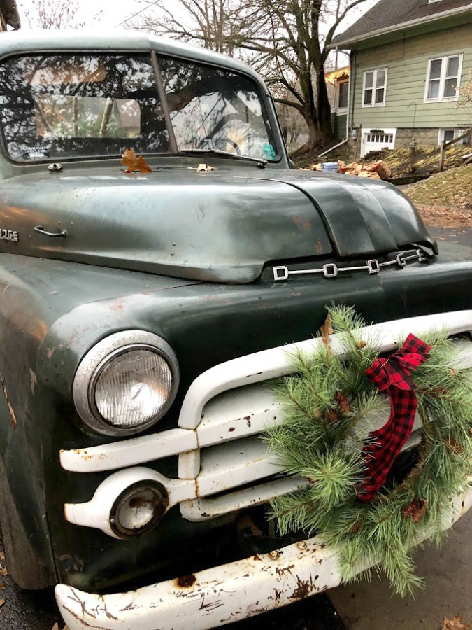 Vintage pickup truck decorated with wreath for Christmas at Urban Farmgirl - Hello Lovely Studio.