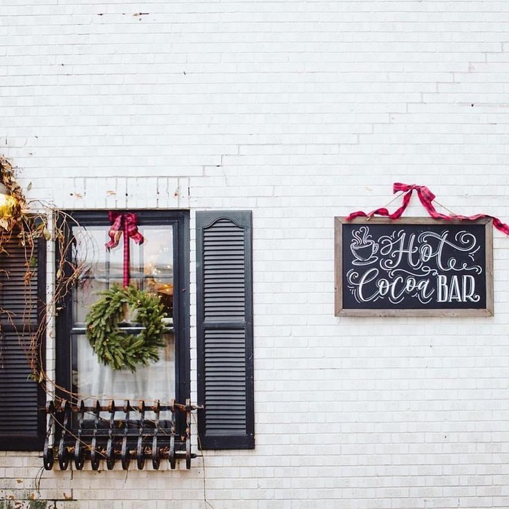 White brick farmhouse exterior with black shutters - Urban Farmgirl's holiday open house 2019.