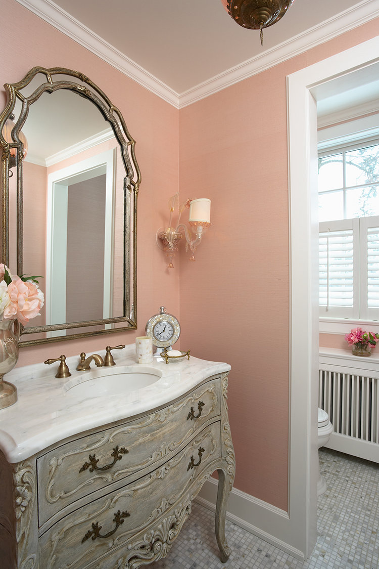 Pretty and elegant bath with warm peachy pink walls - RLH Studios.