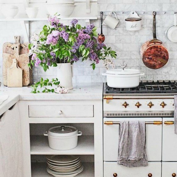 White Country french farmhouse decor inspiration in a kitchen with Lacanche range, white marble, and copper pots. #dreamywhites #fernchcountrykitchen #frenchkitchen #frenchfarmhouse #interiordesign #kitchendesign