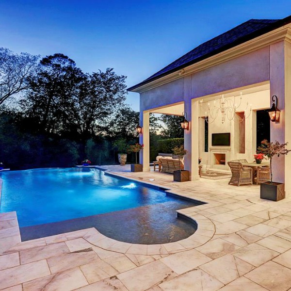 Pool and patio area of luxurious Houston mansion by Thomas O'Neill Homes. #pooldesign #luxuryhomedesign #backyardoasis