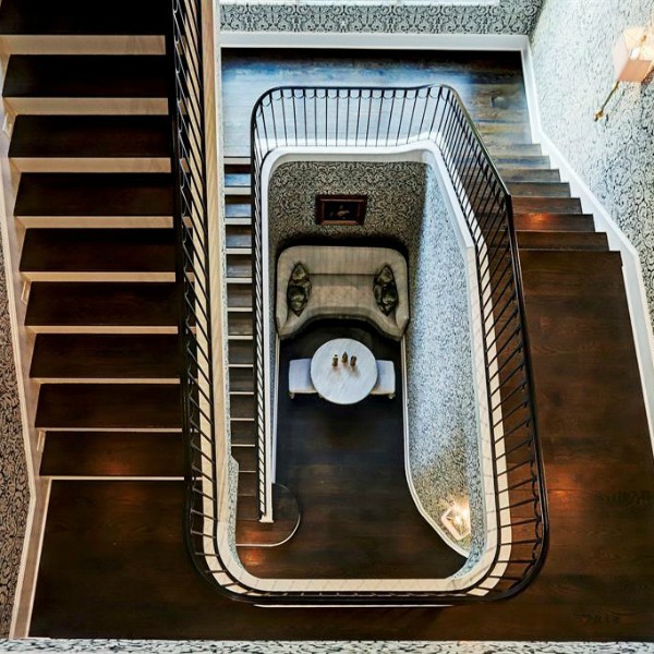 Magnificent architectural wonder of a staircase in a French country Houston mansion by Thomas O'Neill Homes. #frenchcountry #staircase #interiordesign #luxuryhomedesign