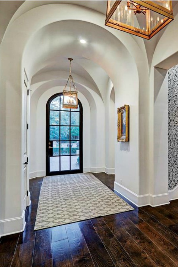 Architectural ceiling arches in an elegant hall of a French country Houston mansion by Thomas O'Neill Homes. #entry #interiordesign #frenchcountry #luxuryhomedesign