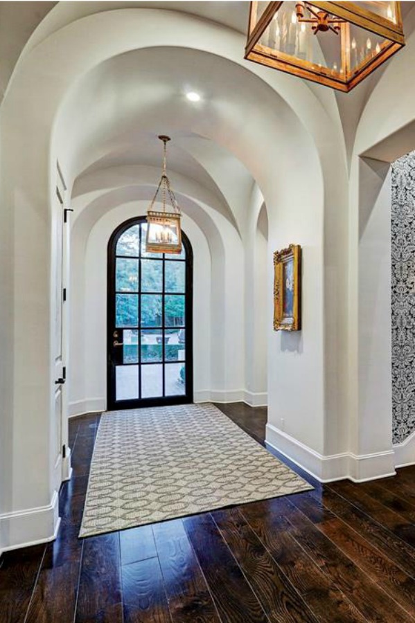 Architectural ceiling arches in an elegant hall of a French country Houston mansion by Thomas O'Neill Homes. #entry #interiordesign #frenchcountry #luxuryhomedesign