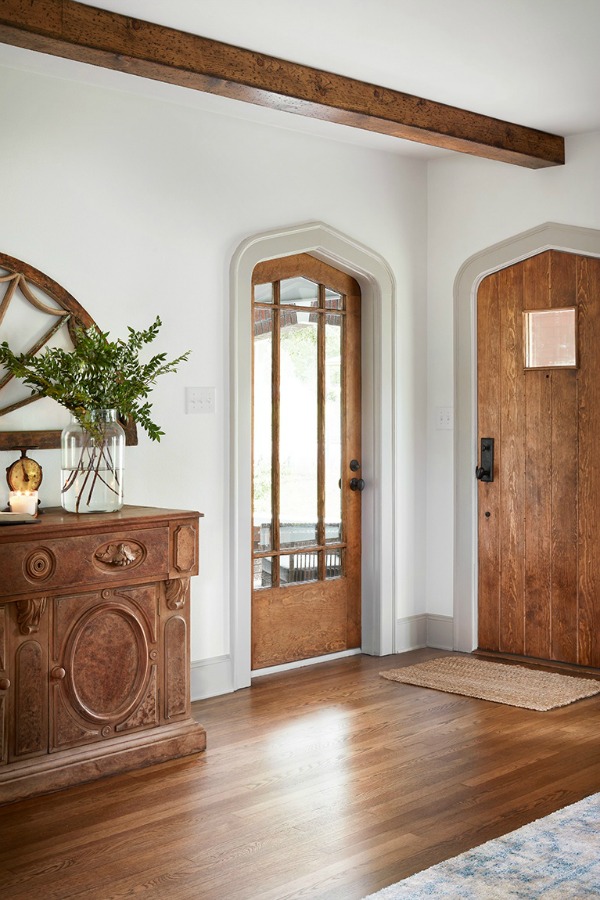 Beautiful entry!  Come get inspired by Tranquil and Timeless Tudor Design Details From a Serene 1920s Texas Cottage renovated on HGTV's Fixer Upper by Chip and Joanna and known as the Scrivano House. #fixerupper #scrivano #cottagestyle #interiordesign #greytrim #serenedecor #entry #cottages