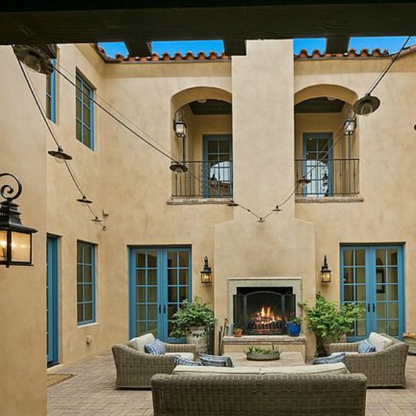 Elegant French Country home exterior in Scottsdale with stucco and arched doors. #houseexterior #frenchcountry #scottsdale