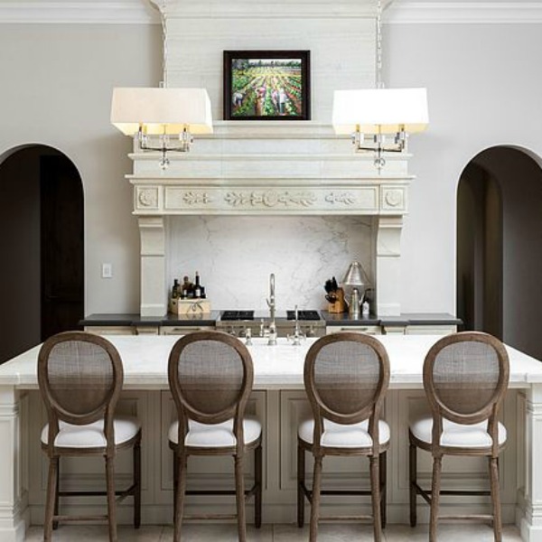 Sophisticated white French country kitchen with Louis style counter stools in a magnificent and classic Scottsdale home. #kitchendesign #frenchcountry #luxuriouskitchen #scottsdalehome