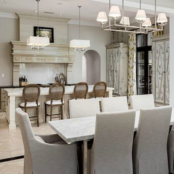 Sophisticated white French country kitchen with Louis style counter stools in a magnificent and classic Scottsdale home. #kitchendesign #frenchcountry #luxuriouskitchen #scottsdalehome