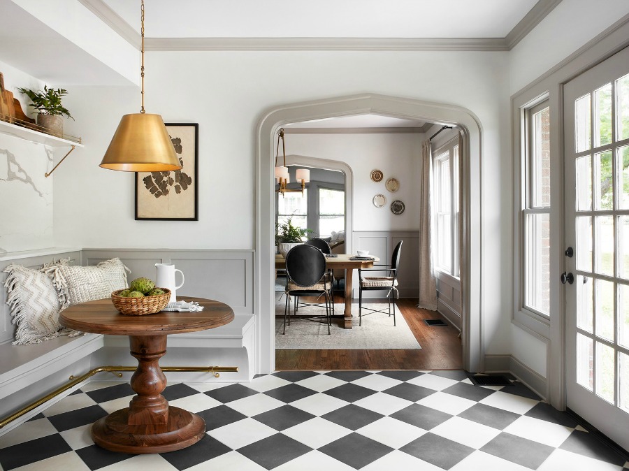 Checkered floors in a vintage style kitchen! This tranquil Tudor cottage was renovated on HGTV's Fixer Upper by Chip and Joanna and is known as the Scrivano House. #fixerupper #scrivano #cottagestyle #interiordesign #greytrim #serenedecor