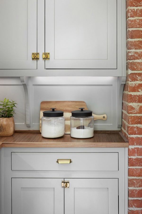 Gorgeous grey kitchen cabinets! This tranquil Tudor cottage was renovated on HGTV's Fixer Upper by Chip and Joanna and is known as the Scrivano House. #fixerupper #scrivano #cottagestyle #interiordesign #greytrim #serenedecor