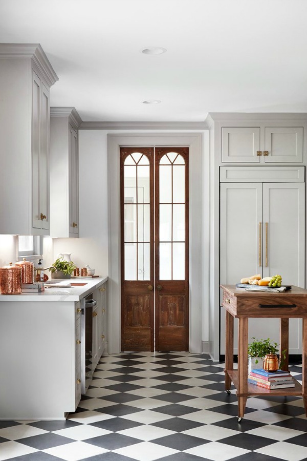 Reclaimed wood doors in kitchen. This tranquil Tudor cottage was renovated on HGTV's Fixer Upper by Chip and Joanna and is known as the Scrivano House. #fixerupper #scrivano #cottagestyle #interiordesign #greytrim #serenedecor