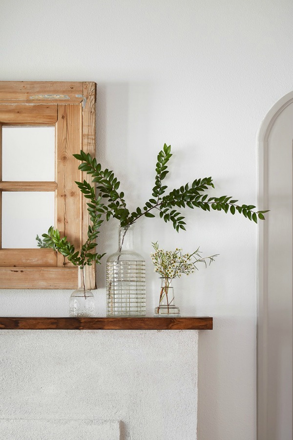 Simple mantelscape. This tranquil Tudor cottage was renovated on HGTV's Fixer Upper by Chip and Joanna and is known as the Scrivano House. #fixerupper #scrivano #cottagestyle #interiordesign #greytrim #serenedecor