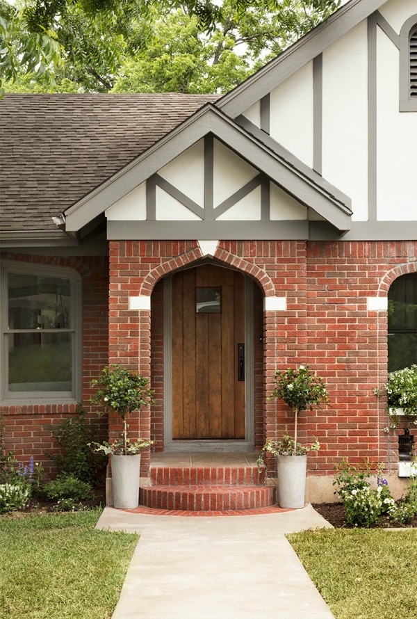 Brick Tudor exterior.  Come get inspired by Tranquil and Timeless Tudor Design Details From a Serene 1920s Texas Cottage renovated on HGTV's Fixer Upper by Chip and Joanna and known as the Scrivano House. #fixerupper #scrivano #tudorcottage #cottageexterior #homeexteriors