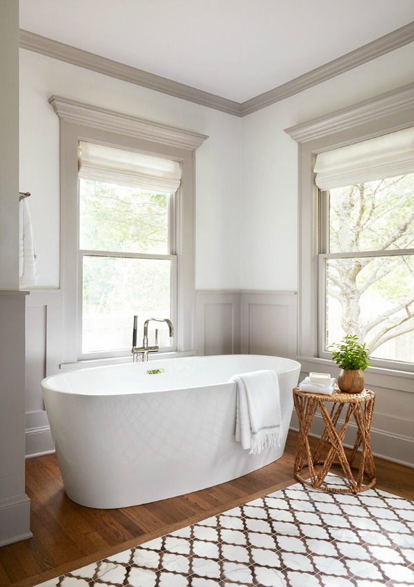 Luxurious tub in vintage style bathroom. This tranquil Tudor cottage was renovated on HGTV's Fixer Upper by Chip and Joanna and is known as the Scrivano House. #fixerupper #scrivano #cottagestyle #interiordesign #greytrim #serenedecor #bathroomdesign