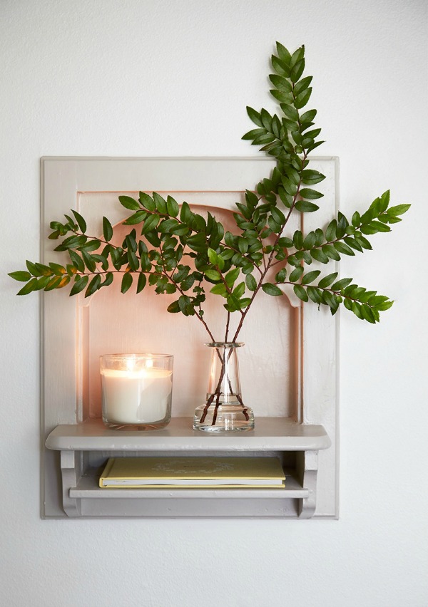 Grey painted trim, simple greenery, and clear glass for a modernized traditional farmhouse vignette. Come get inspired by Tranquil and Timeless Tudor Design Details From a Serene 1920s Texas Cottage renovated on HGTV's Fixer Upper by Chip and Joanna and known as the Scrivano House. #fixerupper #scrivano #cottagestyle #interiordesign #greytrim #serenedecor