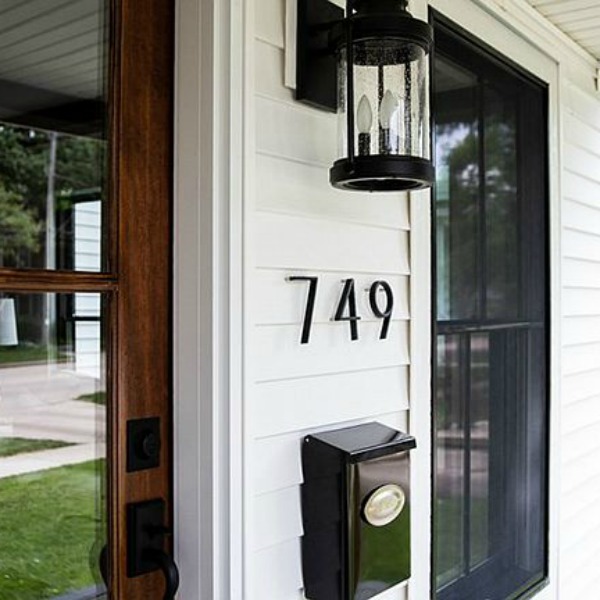 Black and white exterior design elements on a renovated urban farmhouse in Beloit, WI. #hellolovelystudio #blackandwhitedecor #urbanfarmhouse #houseexterior