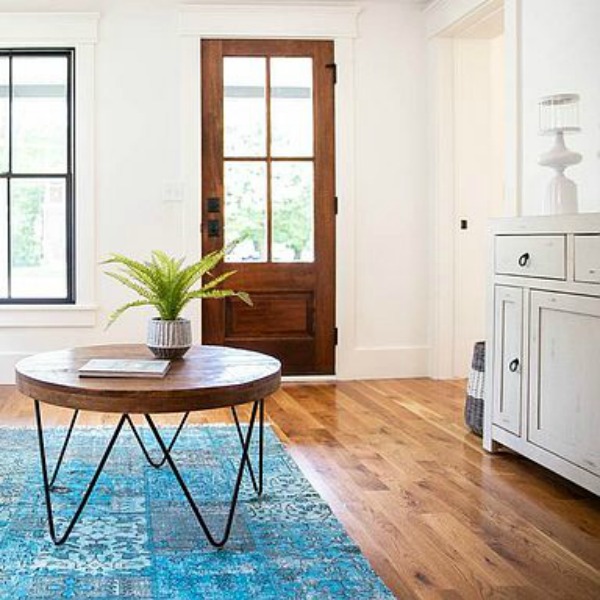 Urban farmhouse living room design with rustic beams, black windows, wood floors, and white sofa. #hellolovelystudio #urbanfarmhouse #interiordesign #modernfarmhouse #livingroom