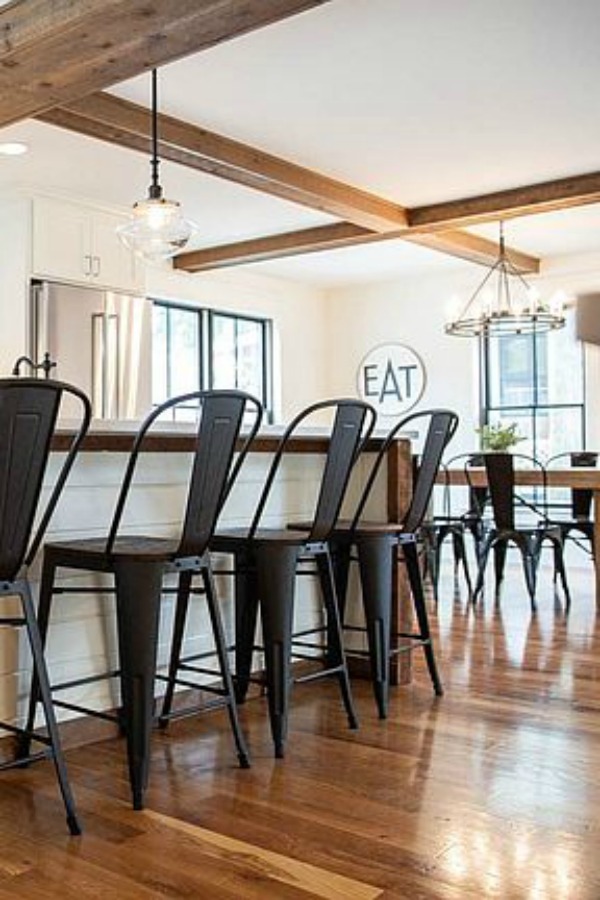 Urban farmhouse kitchen design with rustic beams, island, and metal stools. #hellolovelystudio #urbanfarmhouse #farmhousekitchen #modernfarmhousekitchen