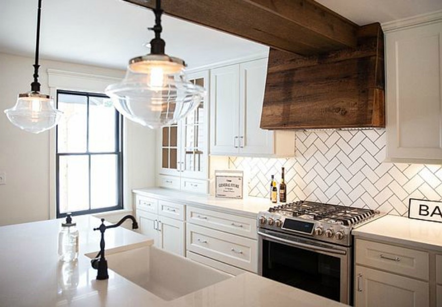 Urban farmhouse kitchen design with rustic beams, island, and metal stools. #hellolovelystudio #urbanfarmhouse #farmhousekitchen #modernfarmhousekitchen